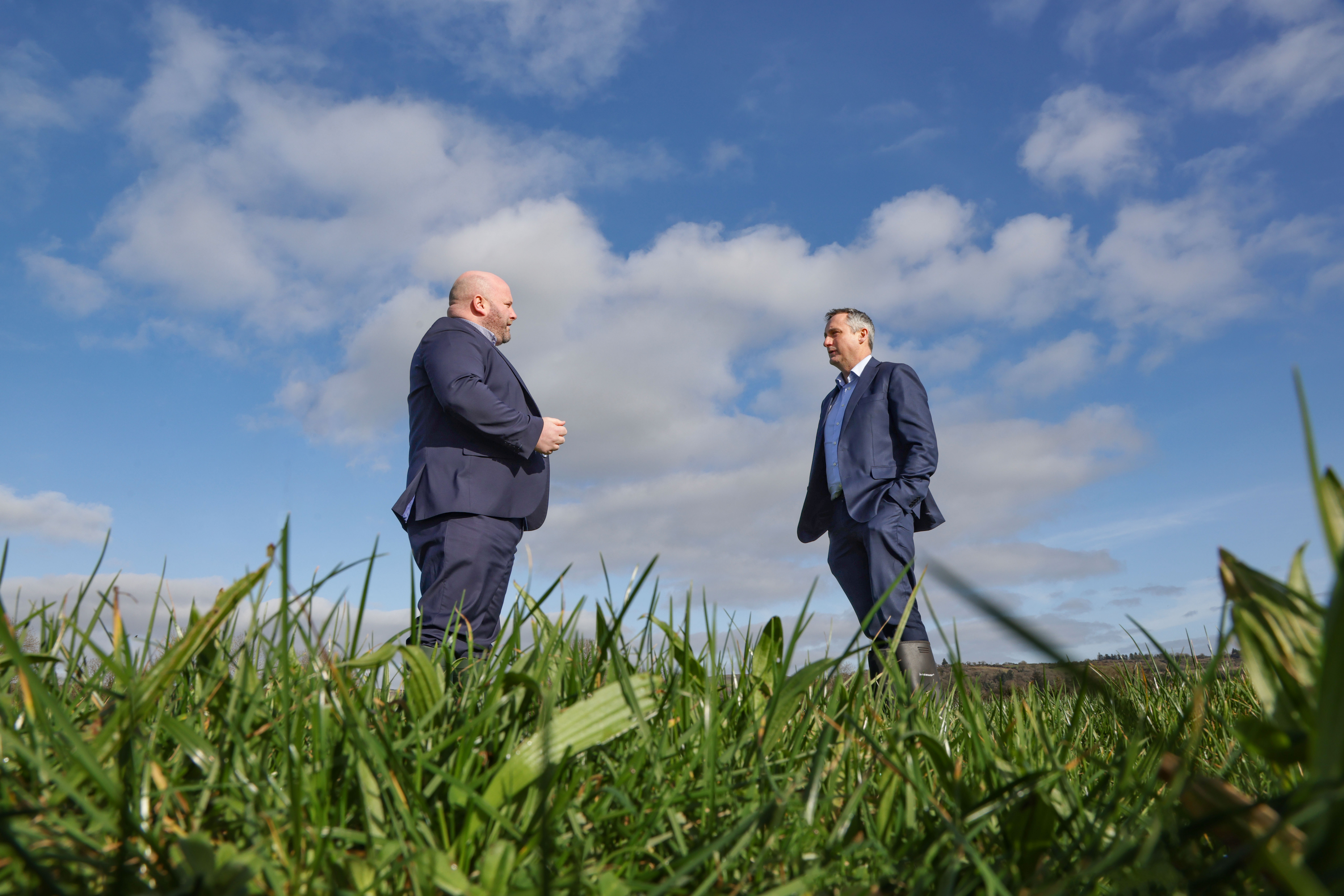 2 men in a field in suits